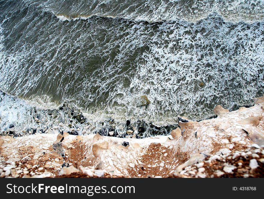 Gray waves on a sea and a rocky brown coast, Beachy Head, September 2007, UK. Gray waves on a sea and a rocky brown coast, Beachy Head, September 2007, UK