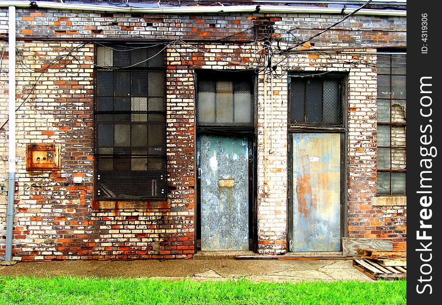 Two doors in the sides of old, run-down buildings. Two doors in the sides of old, run-down buildings