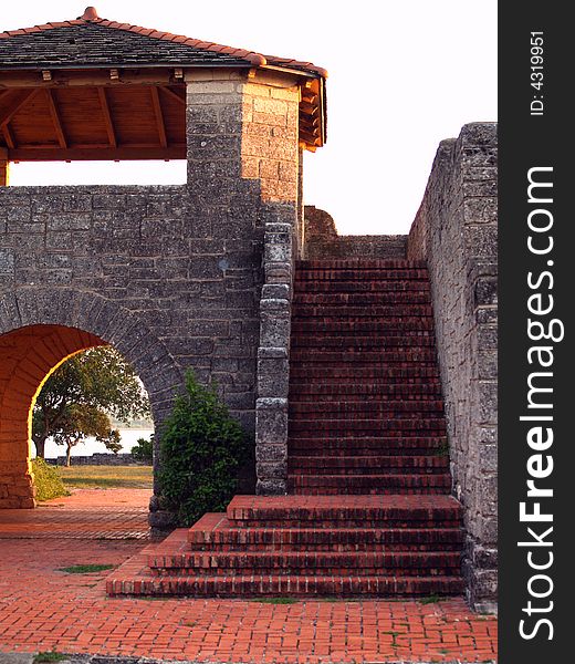 Red brick stairs surrounded by gray stone walls. Red brick stairs surrounded by gray stone walls