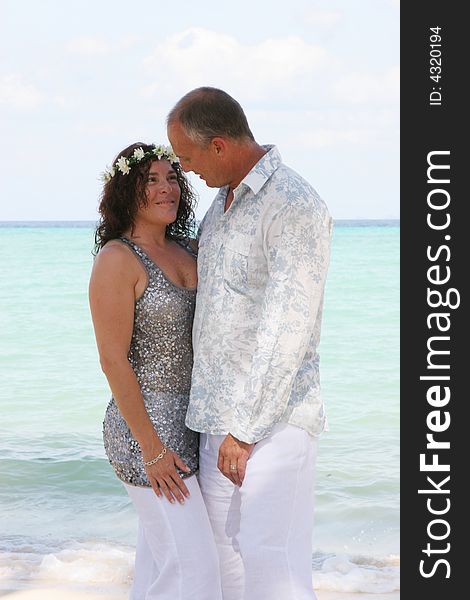 Bride and groom on their tropical beach destination wedding day. Bride and groom on their tropical beach destination wedding day.