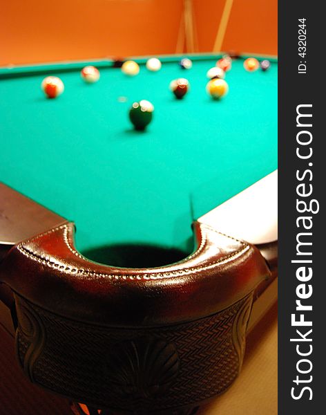 View of a billiard table from corner pocket
