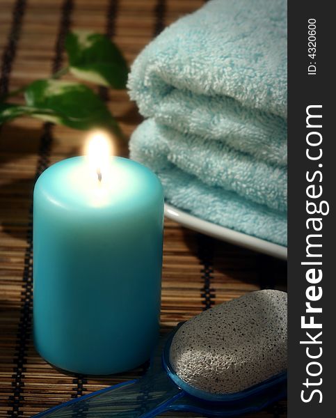 Blue candle and towel and pumice. Blue candle and towel and pumice