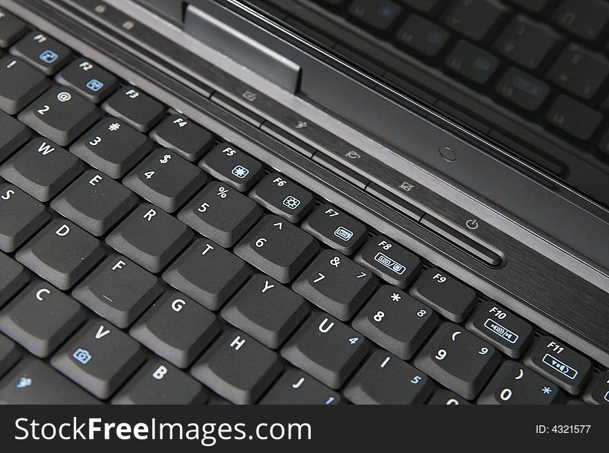 Black modern notebook keyboard close up