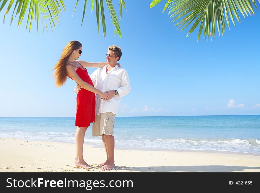 A portrait of attractive couple having date on the beach. A portrait of attractive couple having date on the beach