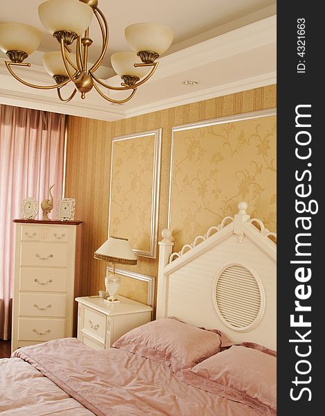 A pink comfortable bed in a beautiful bedroom.