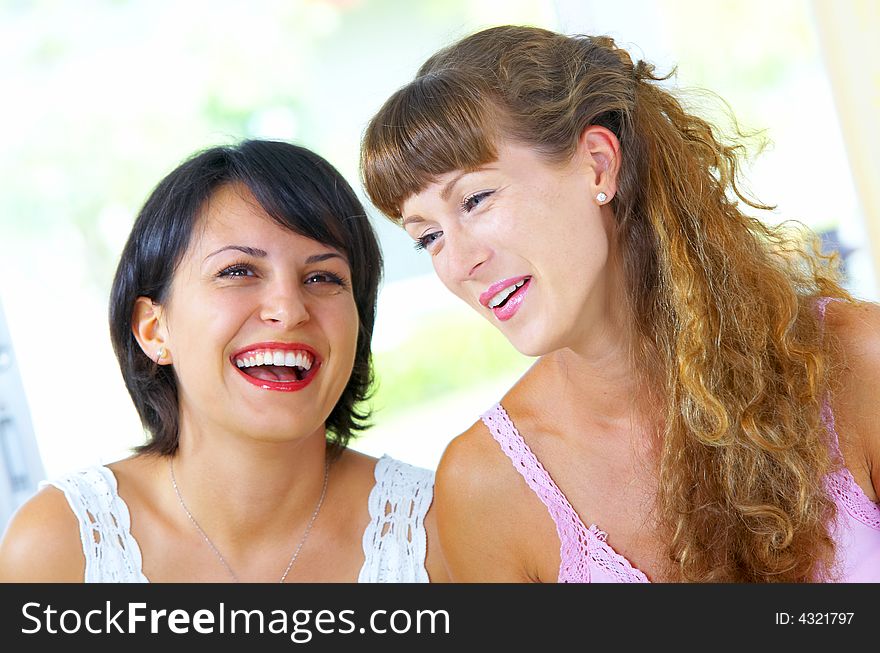 High key portrait of two young females laughing on something. High key portrait of two young females laughing on something