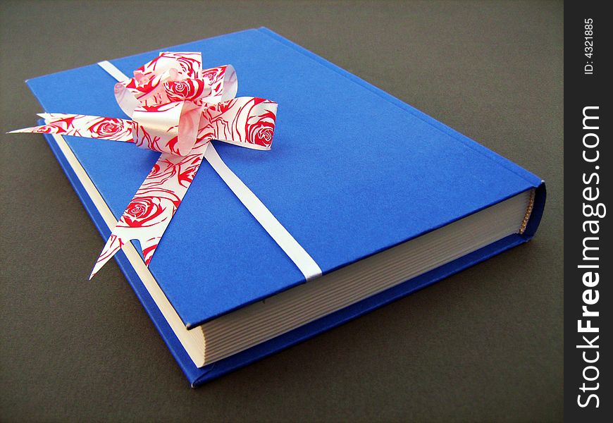 Present book with bow on white