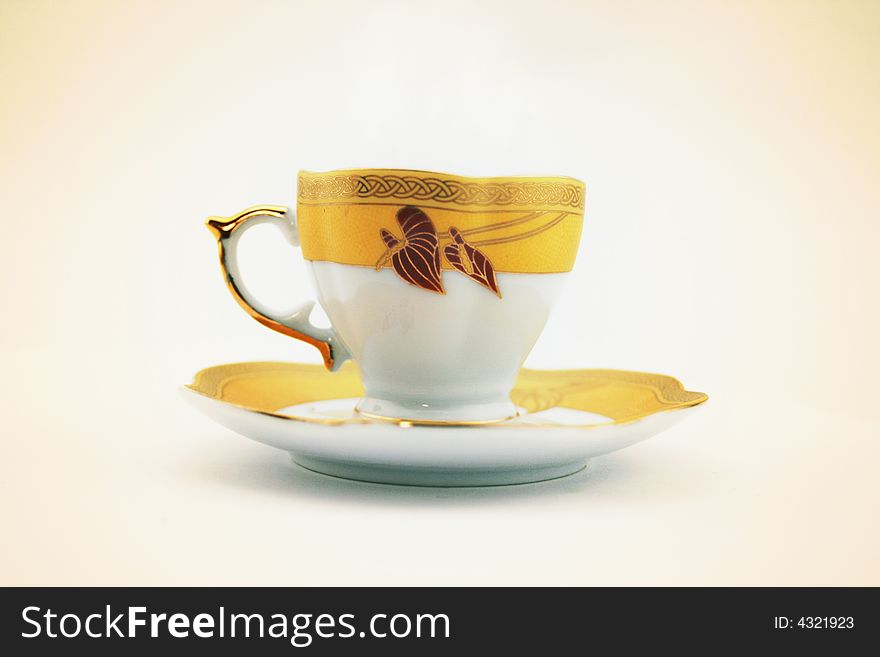 Ceramic cup on saucer on white