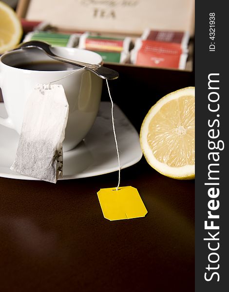 Cup of yellow tea bag with lemon. Cup of yellow tea bag with lemon
