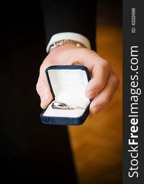 Wedding rings held in grooms hand