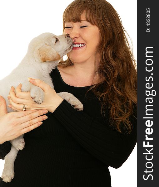 Caucasian girl playing with cream labrador mixed puppy. Caucasian girl playing with cream labrador mixed puppy