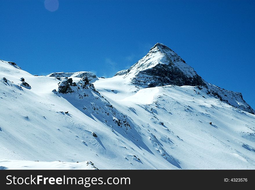 Snowy mountain on sunny winter day in Italian Alps. Snowy mountain on sunny winter day in Italian Alps