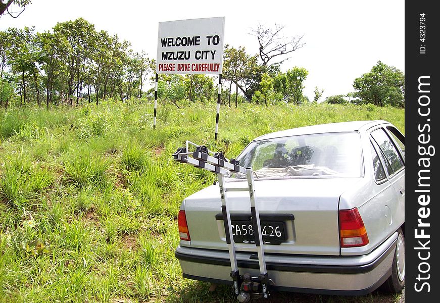 This is a welcome sign The small city known as Mzuzu. The allowed speed is 80 Km per hour. This is a welcome sign The small city known as Mzuzu. The allowed speed is 80 Km per hour.