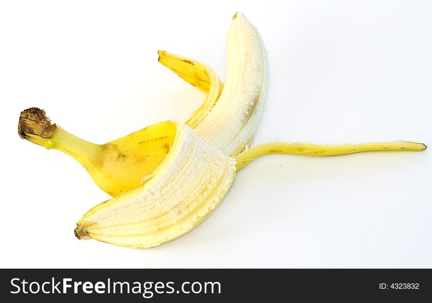 Peeled and whole banana with and without tomatos on glass plate on white background. Peeled and whole banana with and without tomatos on glass plate on white background