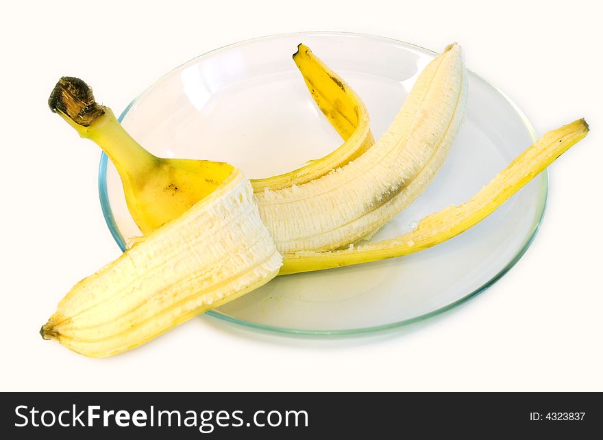 Peeled banana on glass plate on white background