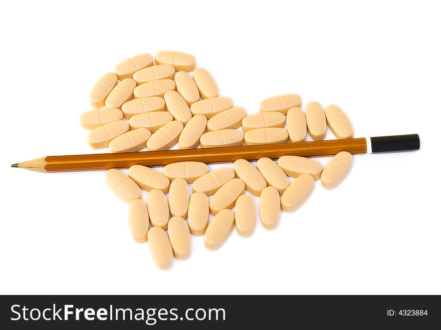 Heart-shaped pile of pills splited by half with pencil on white background. Heart-shaped pile of pills splited by half with pencil on white background