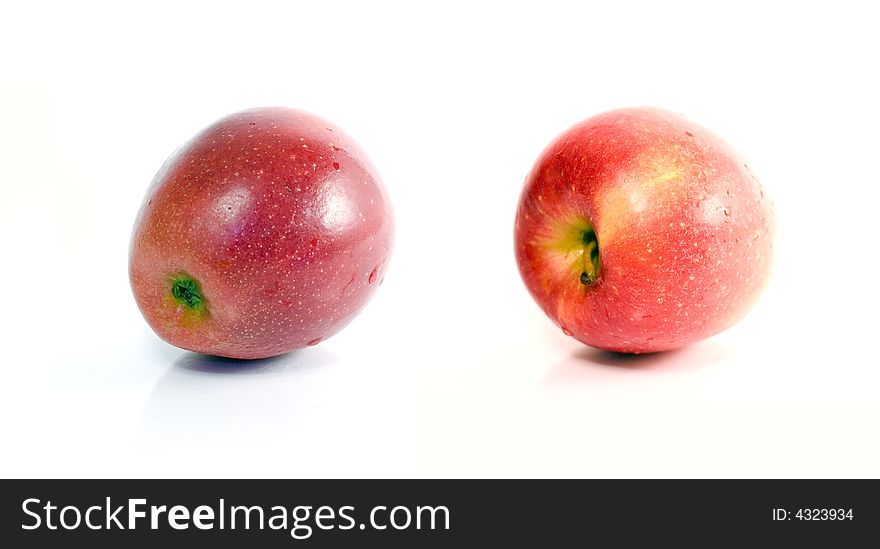 Two ripe red apples from different angles on white background