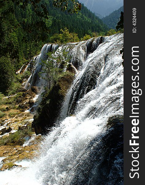 Waterfall in Jiuzaigou nature protection area, Sichuan province, South-West China.

Jiuzaigou translates to: nine village valley.