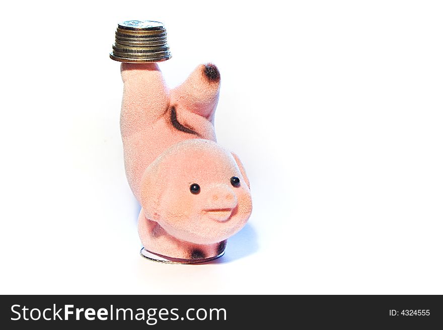 Finger puppet in the shape of a pig, balancing coins on a finger. Finger puppet in the shape of a pig, balancing coins on a finger.