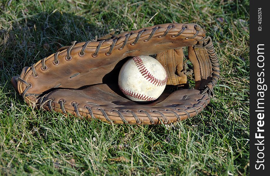 Baseball Glove And Ball In The Grass