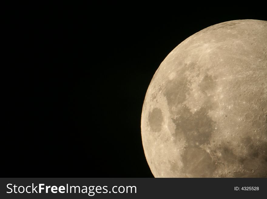 Closeup rising moon, with visible craters