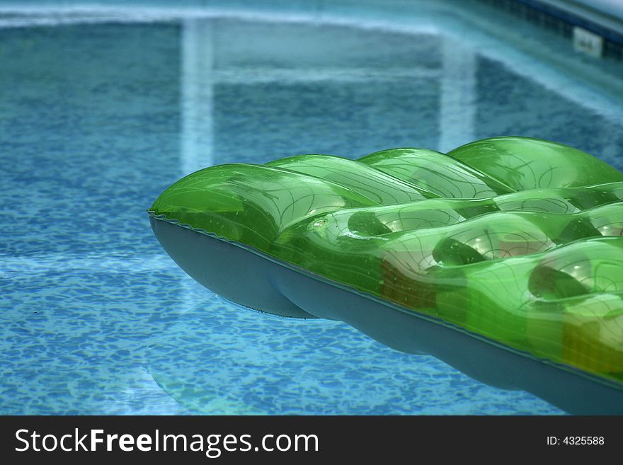 Inflatable bed floating on private swiming pool