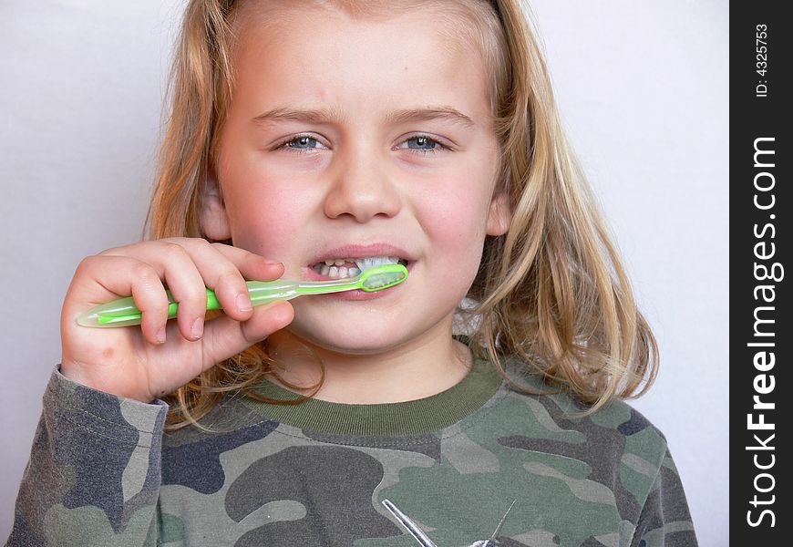 The child brushing the teeth. The child brushing the teeth