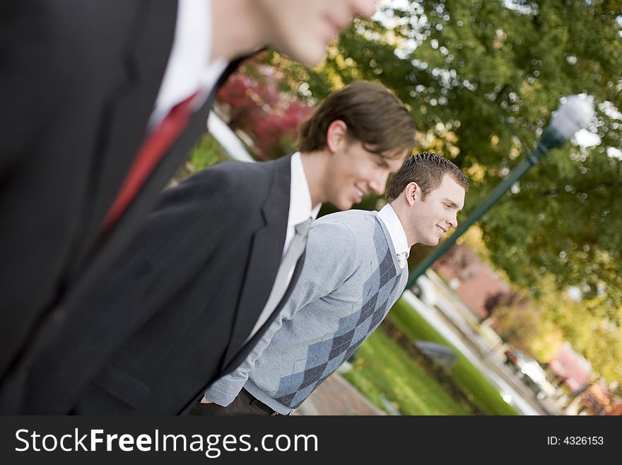 Three business men standing and smiling in same direction. Three business men standing and smiling in same direction