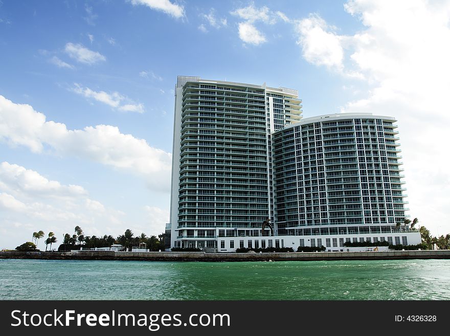 Luxurious high rise Condominiums with deep blue sky background and water foreground. Luxurious high rise Condominiums with deep blue sky background and water foreground