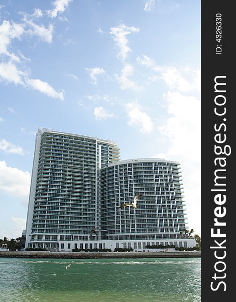 Luxurious high rise Condominiums with deep blue sky background and water foreground. Luxurious high rise Condominiums with deep blue sky background and water foreground