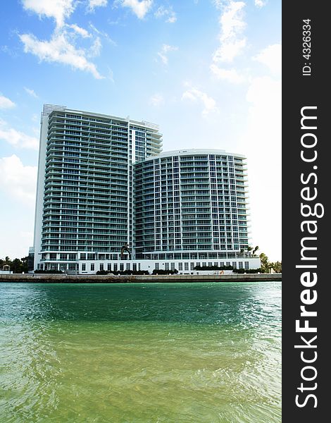 Luxurious high rise Condominiums with deep blue sky background and water foreground. Luxurious high rise Condominiums with deep blue sky background and water foreground