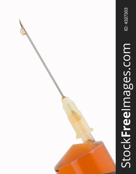 Needle of syringe with drop on white background