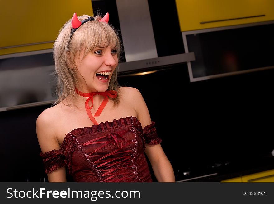 Beauty blond devil lauging at halloween party. Beauty blond devil lauging at halloween party