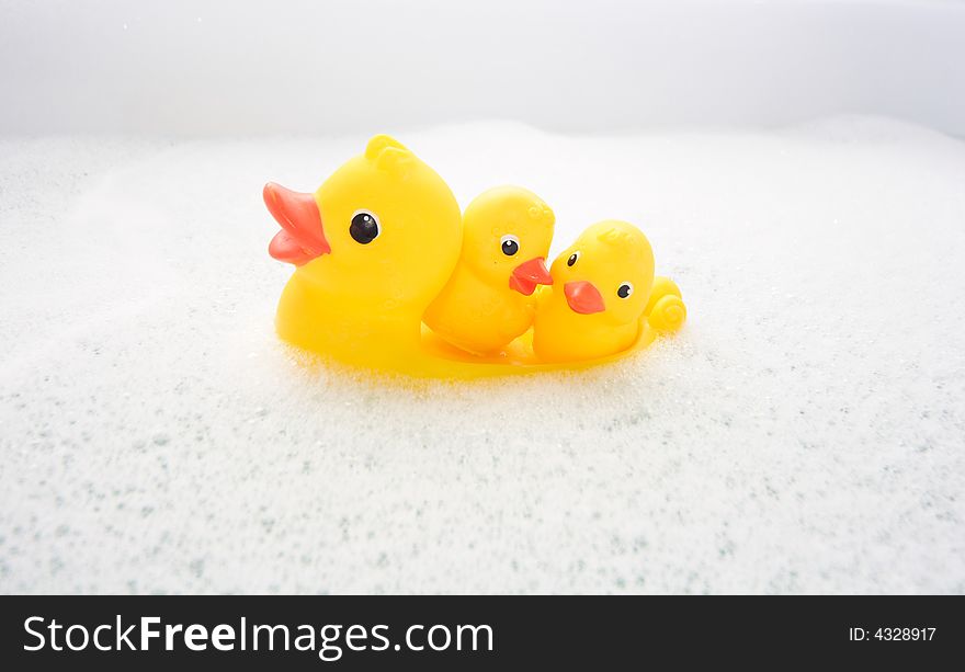 Three Rubber Ducks In Foam Water