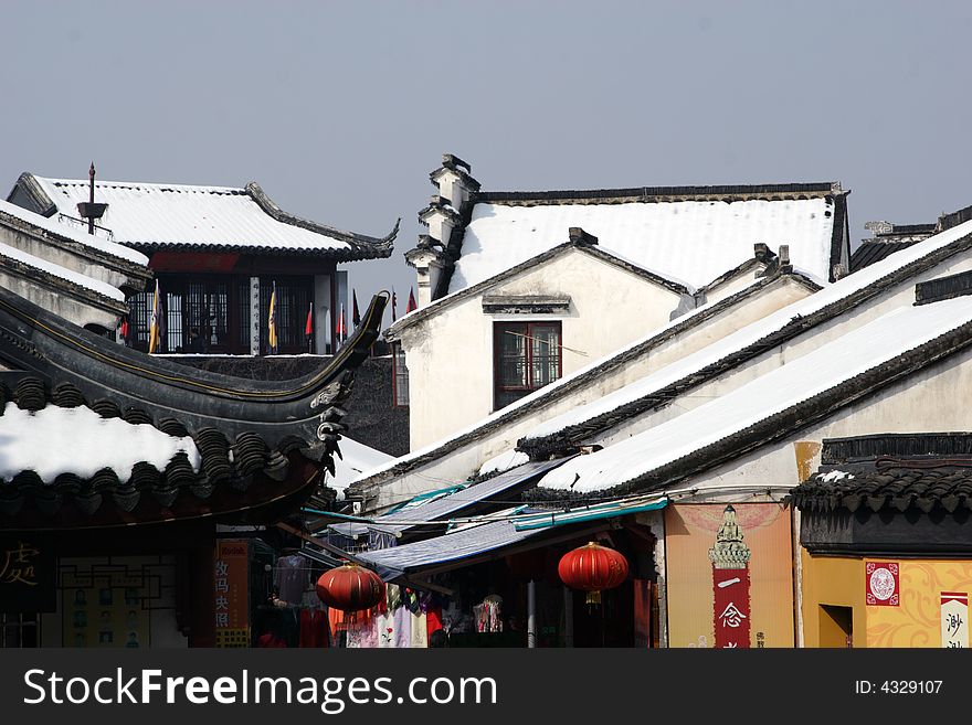 The beautiful and enjoyable snow scenery in the winter in the southern part of China. These sceneries are famous for their snow ,water, houses,and the blue sky.They are typical of the south in China.This picture is taken in the place of interest“Mooring by the Feng Bridge at night” in Suzhou ,China.