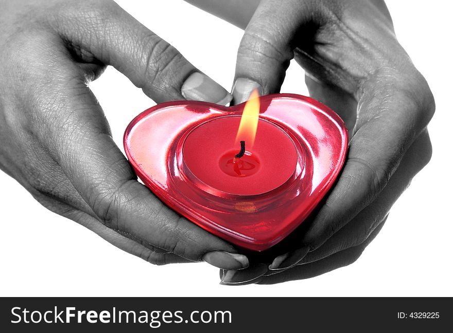 Female hands holding red heart shaped candle.Isolated on white background.