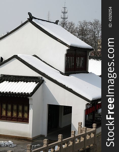 The beautiful and enjoyable snow scenery in the winter in the southern part of China. These sceneries are famous for their snow ,water, houses,and the blue sky.They are typical of the south in China.This picture is taken in the place of interestâ€œMooring by the Feng Bridge at nightâ€ in Suzhou ,China.