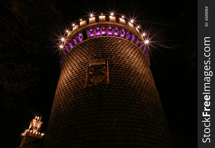 A tower of Castello Sforzesco in Milan by night. A tower of Castello Sforzesco in Milan by night
