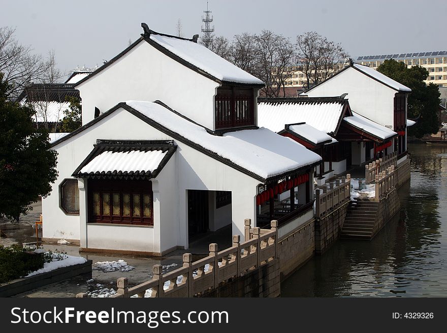 The beautiful and enjoyable snow scenery in the winter in the southern part of China. These sceneries are famous for their snow ,water, houses,and the blue sky.They are typical of the south in China.This picture is taken in the place of interest“Mooring by the Feng Bridge at night” in Suzhou ,China.