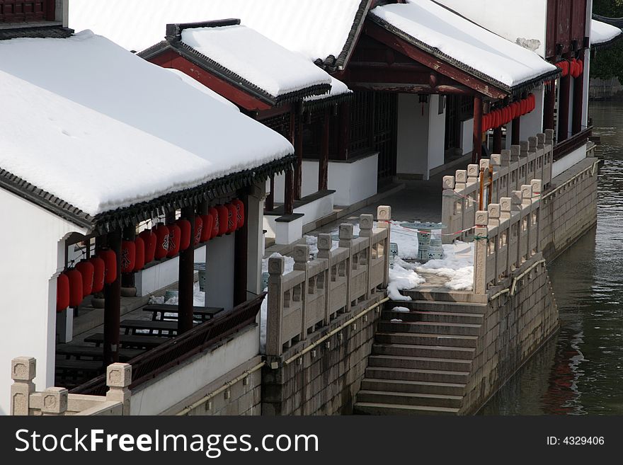 The beautiful and enjoyable snow scenery in the winter in the southern part of China. These sceneries are famous for their snow ,water, houses,and the blue sky.They are typical of the south in China.This picture is taken in the place of interest“Mooring by the Feng Bridge at night” in Suzhou ,China.