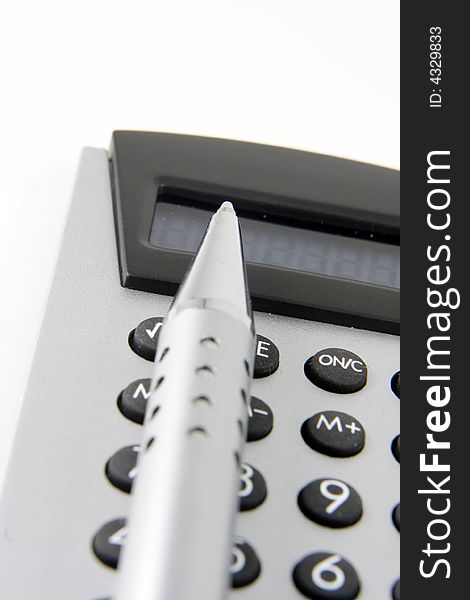 Silver calculator and metal pen. Silver calculator and metal pen