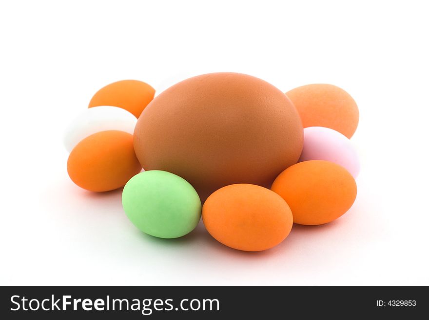 Egg surrounded by little colored Easter eggs on white background. Egg surrounded by little colored Easter eggs on white background