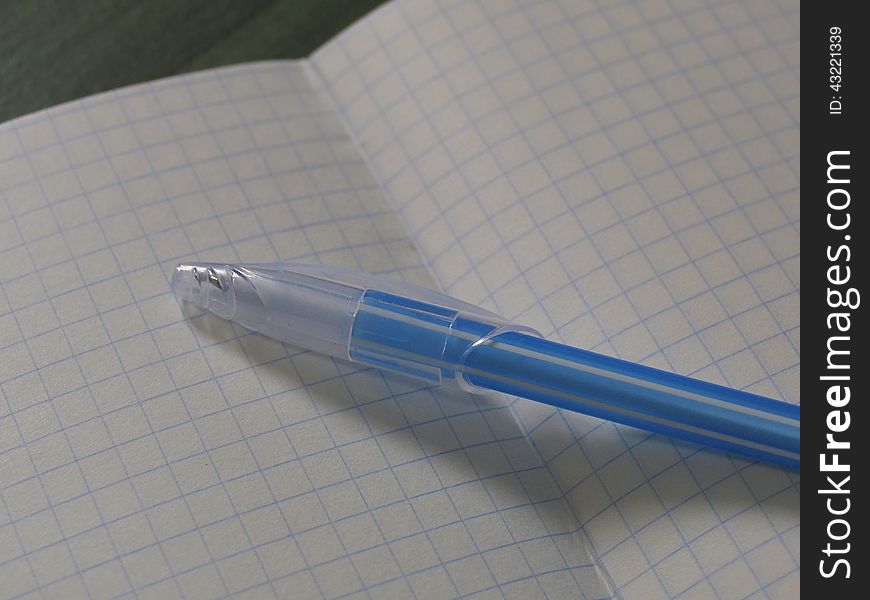 Back to school concept. Turn the notebook into a line with two pencils on the table