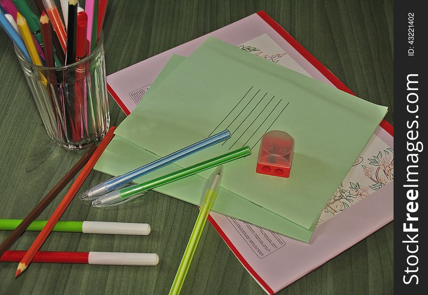 Back to school concept. School stationery set on the desk - notebooks, album, pens, pencils, markers, sharpener