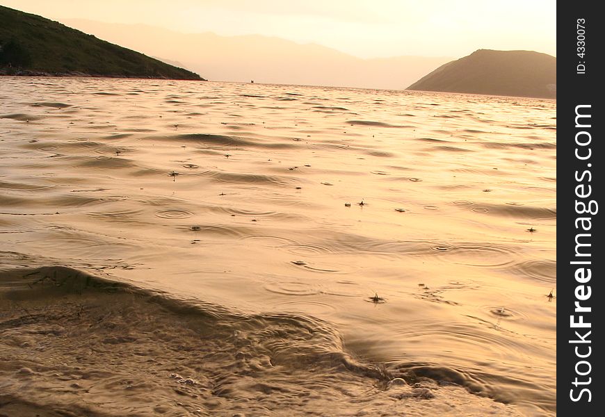 Beautiful sunset on the beach during the rain