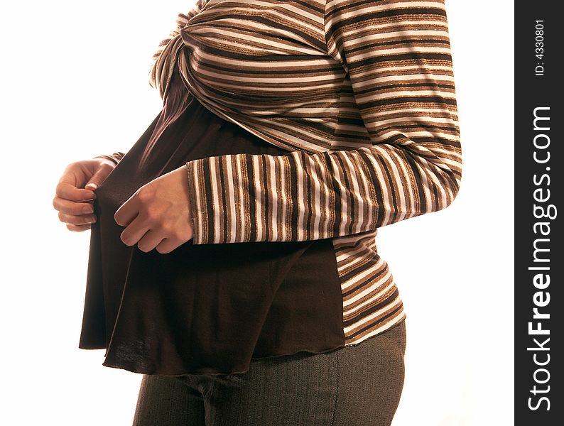 The pregnant woman on a white background. In hands holds small boots