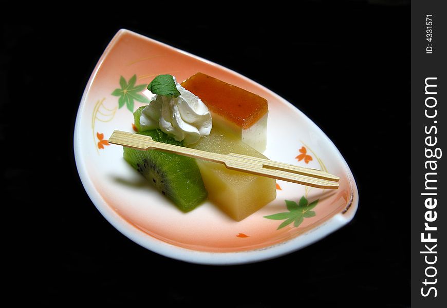 Fruits and cake dessert plate, served in a Japanese specific manner, isolated on black. Fruits and cake dessert plate, served in a Japanese specific manner, isolated on black.