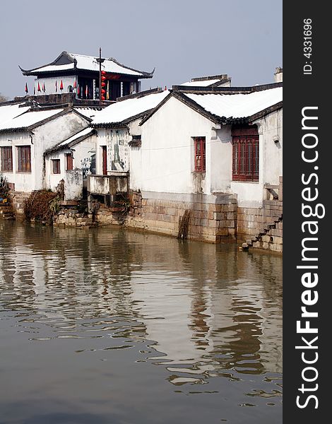 The beautiful and enjoyable snow scenery in the winter in the southern part of China. These sceneries are famous for their snow ,water, houses,and the blue sky.They are typical of the south in China.This picture is taken in the place of interest“Mooring by the Feng Bridge at night” in Suzhou ,China.