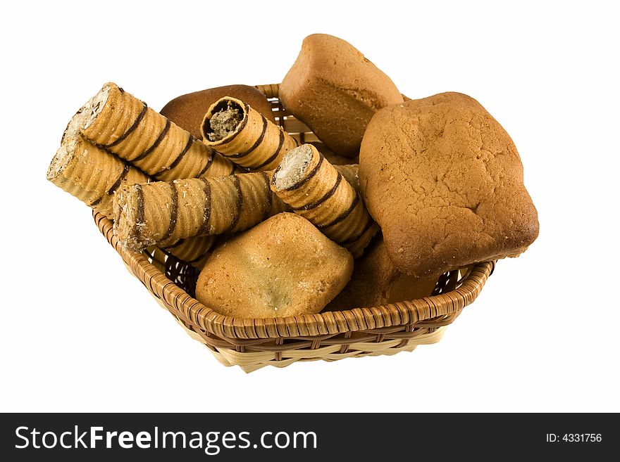 An isolated basket full of bakery foods. An isolated basket full of bakery foods