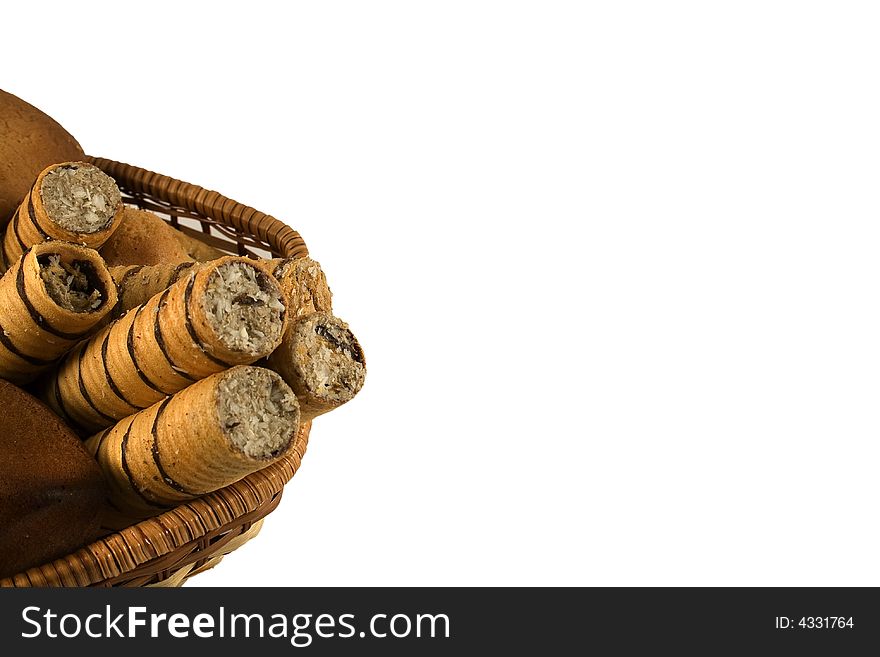 An isolated basket full of bakery foods. Blank space for your text or logo. An isolated basket full of bakery foods. Blank space for your text or logo.